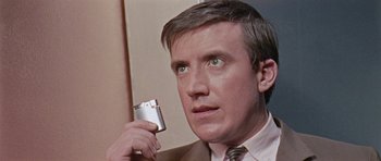 Movie still from “Dr. Who and the Daleks” (1965), directed by Gordon Flemyng – A person holding a cell phone; Close Up shot, Low angle