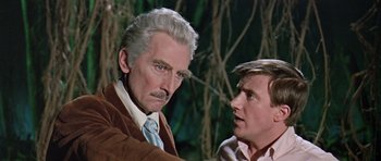 Movie still from “Dr. Who and the Daleks” (1965), directed by Gordon Flemyng – A man with a mustache and a man with a tie; Close Up shot, Over the shoulder angle