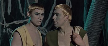 Movie still from “Dr. Who and the Daleks” (1965), directed by Gordon Flemyng – A couple of men standing next to each other; Close Up shot, High angle