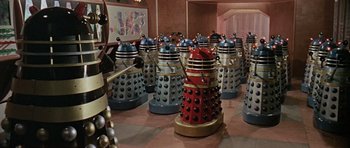 Movie still from “Dr. Who and the Daleks” (1965), directed by Gordon Flemyng – A group of daleks are lined up on the floor; Extreme Wide shot, High angle