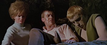 Movie still from “Dr. Who and the Daleks” (1965), directed by Gordon Flemyng – A young man sitting next to another young man; Close Up shot, High angle