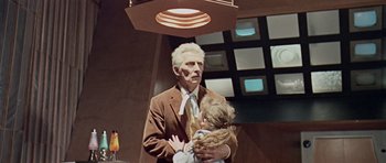 Movie still from “Dr. Who and the Daleks” (1965), directed by Gordon Flemyng – An older man holding a little girl in his arms; Medium shot, Low angle