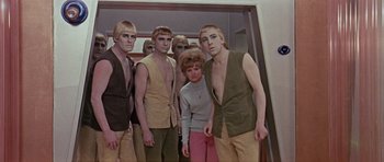 Movie still from “Dr. Who and the Daleks” (1965), directed by Gordon Flemyng – A group of men standing next to each other; Medium shot, High angle