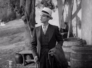 Movie still from “Dracula” (1931), directed by Tod Browning – A black and white photo of a man wearing a suit and hat; Medium shot, High angle