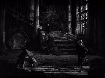 Movie still from “Dracula” (1931), directed by Tod Browning – A black and white photo of a man walking down a staircase; Extreme Wide shot, High angle
