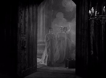 Movie still from “Dracula” (1931), directed by Tod Browning – A group of people standing in front of a door; Wide shot, Low angle