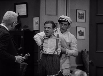 Movie still from “Dracula” (1931), directed by Tod Browning – Two men in a room with one holding a microphone; Medium shot, Over the shoulder angle