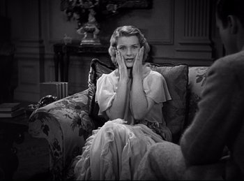 Movie still from “Dracula” (1931), directed by Tod Browning – A black and white photo of a woman sitting on a couch; Medium shot, High angle