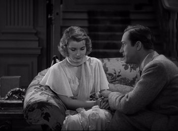 Movie still from “Dracula” (1931), directed by Tod Browning – A man and a woman sitting on a couch; Medium shot, High angle