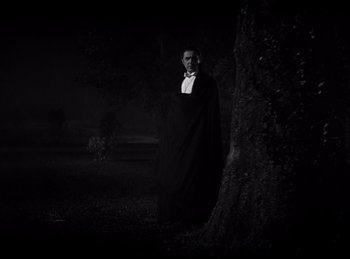 Movie still from “Dracula” (1931), directed by Tod Browning – A man dressed as a vampire standing next to a tree; Wide shot, Low angle