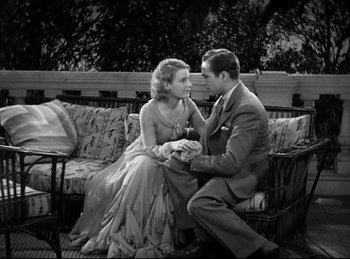 Movie still from “Dracula” (1931), directed by Tod Browning – A man and a woman sitting on a couch together; Medium shot, High angle