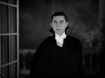 Movie still from “Dracula” (1931), directed by Tod Browning – A black and white photo of a man dressed as dracula; Medium shot, Low angle