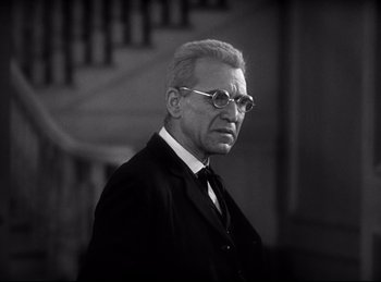 Movie still from “Dracula” (1931), directed by Tod Browning – An older man wearing a suit and tie; Close Up shot, Low angle