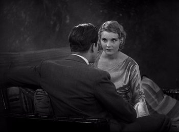 Movie still from “Dracula” (1931), directed by Tod Browning – A man and a woman sitting on a couch; Medium shot, High angle