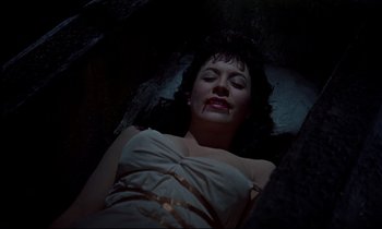 Movie still from “Horror of Dracula” (1958), directed by Terence Fisher – A woman laying on a bed in a dark room; Medium shot, Overhead angle