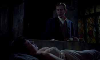 Movie still from “Horror of Dracula” (1958), directed by Terence Fisher – A man standing next to a woman laying on a bed; Medium shot, Over the shoulder angle