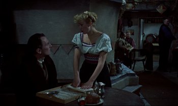 Movie still from “Horror of Dracula” (1958), directed by Terence Fisher – A woman standing at a table in front of a man; Medium shot, Over the shoulder angle
