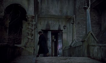 Movie still from “Horror of Dracula” (1958), directed by Terence Fisher – A man walking down the steps of a building; Wide shot, Low angle