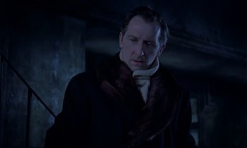Movie still from “Horror of Dracula” (1958), directed by Terence Fisher – A man wearing a coat and a fur scarf; Close Up shot, Low angle