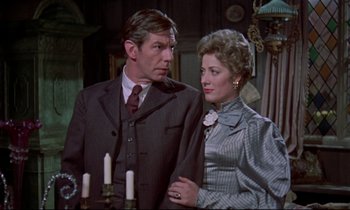 Movie still from “Horror of Dracula” (1958), directed by Terence Fisher – A man and a woman standing next to each other in front of candles; Medium shot, Over the shoulder angle
