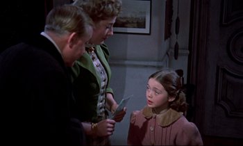 Movie still from “Horror of Dracula” (1958), directed by Terence Fisher – An older couple and a little girl looking at each other; Medium shot, Over the shoulder angle