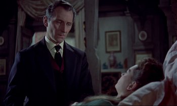 Movie still from “Horror of Dracula” (1958), directed by Terence Fisher – A man wearing a suit and tie standing next to a woman; Medium shot, Over the shoulder angle