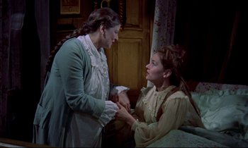 Movie still from “Horror of Dracula” (1958), directed by Terence Fisher – Two women in old - fashioned clothing are holding hands; Medium shot, High angle
