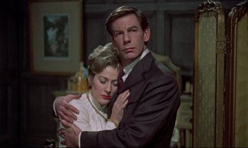 Movie still from “Horror of Dracula” (1958), directed by Terence Fisher – A man and a woman embracing in a living room; Medium shot, High angle