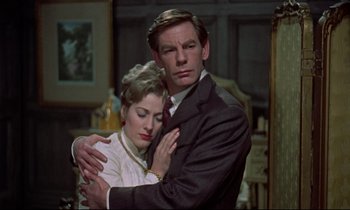 Movie still from “Horror of Dracula” (1958), directed by Terence Fisher – A man and a woman embracing in a living room; Medium shot, Low angle