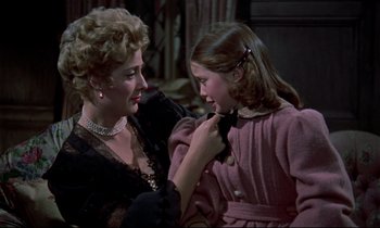 Movie still from “Horror of Dracula” (1958), directed by Terence Fisher – An older woman and a young girl looking at each other; Medium shot, Over the shoulder angle