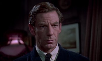 Movie still from “Horror of Dracula” (1958), directed by Terence Fisher – A person wearing a suit and tie; Close Up shot, Over the shoulder angle