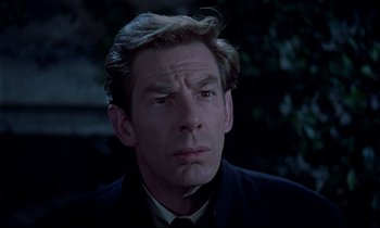 Movie still from “Horror of Dracula” (1958), directed by Terence Fisher – A person wearing a suit and tie; Close Up shot, Low angle