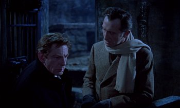 Movie still from “Horror of Dracula” (1958), directed by Terence Fisher – Two men are sitting next to each other; Medium shot, Over the shoulder angle