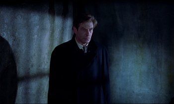 Movie still from “Horror of Dracula” (1958), directed by Terence Fisher – A man in a black coat and a white tie; Medium shot, Low angle