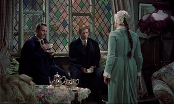 Movie still from “Horror of Dracula” (1958), directed by Terence Fisher – A group of men and women sitting around a table; Medium shot, Over the shoulder angle