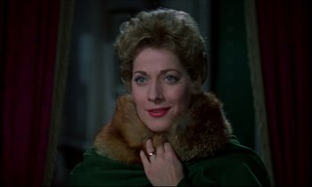 Movie still from “Horror of Dracula” (1958), directed by Terence Fisher – A person wearing a green coat; Close Up shot, Over the shoulder angle