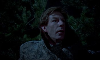 Movie still from “Horror of Dracula” (1958), directed by Terence Fisher – A man in a jacket is standing in front of a tree; Close Up shot, Low angle
