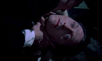 Movie still from “Horror of Dracula” (1958), directed by Terence Fisher – A man in a suit and tie looking up at the camera; Close Up shot, Overhead angle