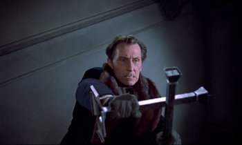 Movie still from “Horror of Dracula” (1958), directed by Terence Fisher – A man in a black jacket and a red fur coat; Medium shot, Low angle