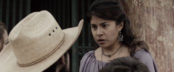 Movie still from “Drag Me to Hell” (2009), directed by Sam Raimi – A woman wearing a cowboy hat is looking at the camera; Close Up shot, Over the shoulder angle