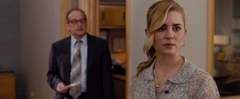 Movie still from “Drag Me to Hell” (2009), directed by Sam Raimi – A man and a woman standing next to each other in a room; Close Up shot, Over the shoulder angle