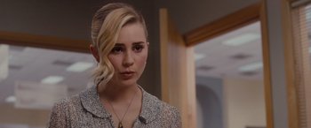 Movie still from “Drag Me to Hell” (2009), directed by Sam Raimi – A young woman with blonde hair wearing a white shirt; Close Up shot, Over the shoulder angle