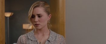 Movie still from “Drag Me to Hell” (2009), directed by Sam Raimi – A woman with blonde hair wearing a white and black shirt; Close Up shot, Over the shoulder angle