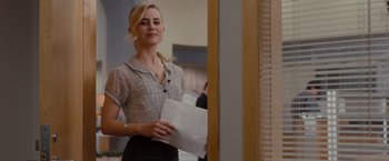 Movie still from “Drag Me to Hell” (2009), directed by Sam Raimi – A woman standing in front of a mirror holding a paper bag; Medium shot, Over the shoulder angle