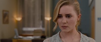 Movie still from “Drag Me to Hell” (2009), directed by Sam Raimi – A person wearing a necklace; Close Up shot, Over the shoulder angle