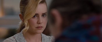 Movie still from “Drag Me to Hell” (2009), directed by Sam Raimi – A person with blonde hair; Close Up shot, Over the shoulder angle