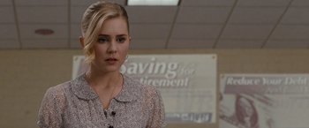Movie still from “Drag Me to Hell” (2009), directed by Sam Raimi – A woman with blonde hair standing in front of a sign; Close Up shot, Over the shoulder angle
