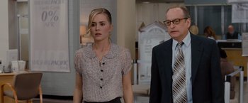 Movie still from “Drag Me to Hell” (2009), directed by Sam Raimi – A woman and a man standing next to each other in a room; Medium shot, Over the shoulder angle