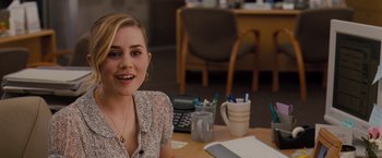 Movie still from “Drag Me to Hell” (2009), directed by Sam Raimi – A woman sitting at a table in front of a calculator; Close Up shot, Over the shoulder angle