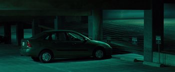 A car parked in a parking garage at night
